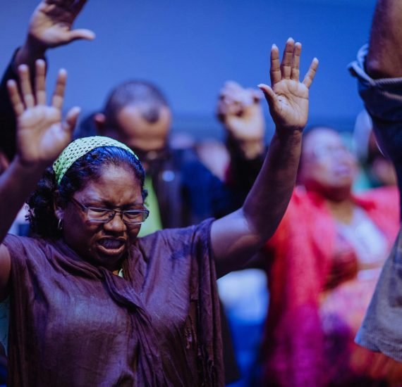 People gathered in a heartfelt prayer meeting, expressing unity and devotion.