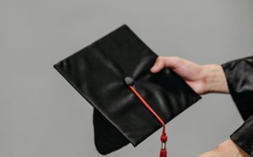 A close-up of a graduation cap and rolled diploma symbolizing achievement and success.